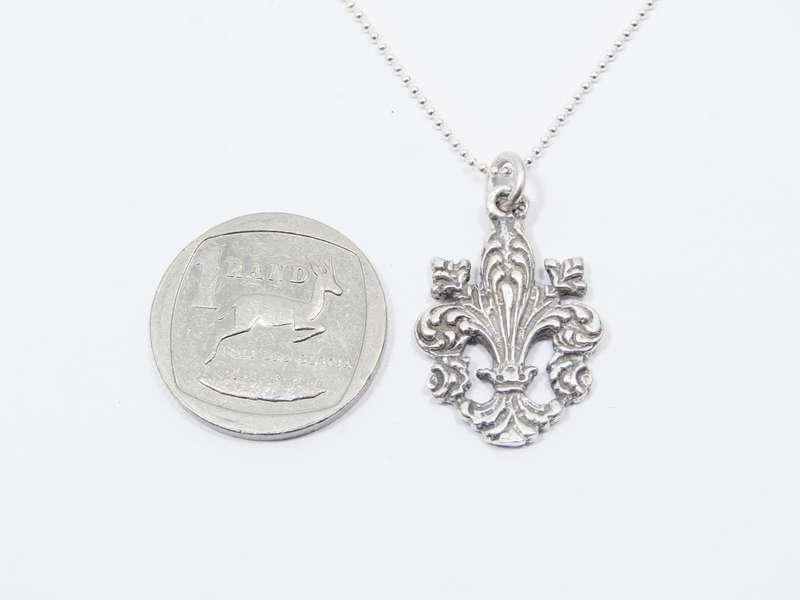 A Stunning Fleur De Lis Pendant on chain in Sterling Silver.