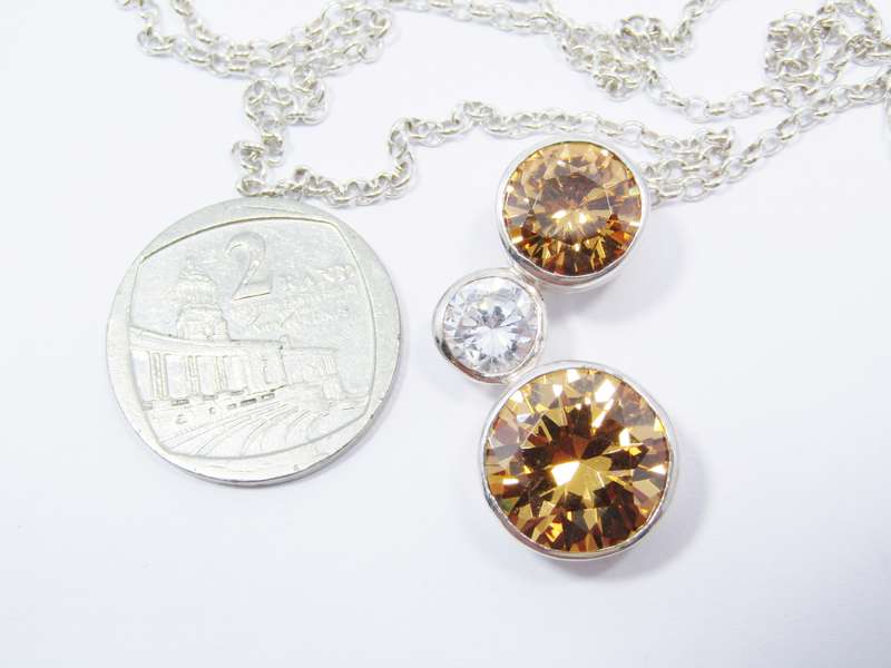 A Beautiful Orange And Clear Zirconia Pendant On Chain in Sterling Silver.