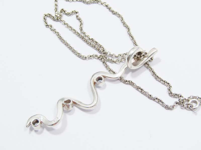 A Beautiful Swirl Design Zirconia Pendant on Chain in Sterling Silver.