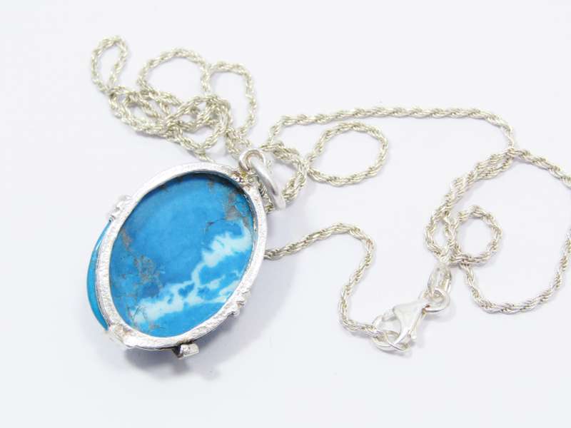 A Gorgeous Turquoise Color Stone Pendant With a Rose Detail on Chain in Sterling Silver