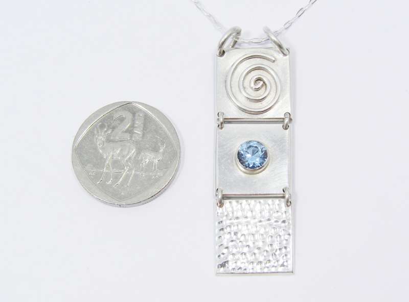 A Lovely 3 Paneled Blue Spinal Pendant on Chain in Sterling Silver.