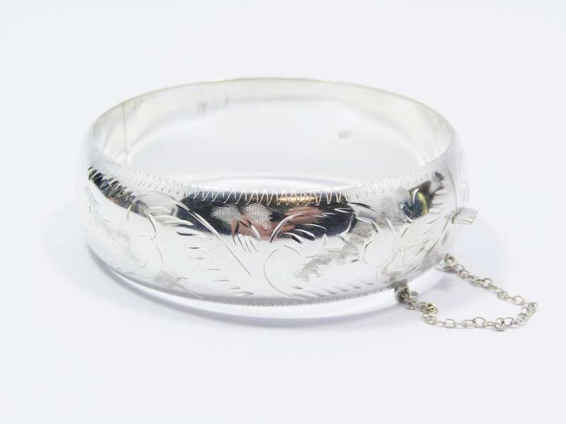 A Gorgeous Broad Engraved Vintage Design Hinged Bangle in Sterling Silver.