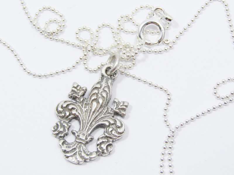 A Stunning Fleur De Lis Pendant on chain in Sterling Silver.