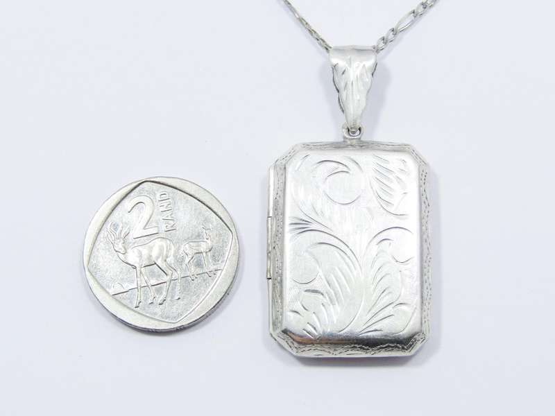 A Gorgeous Large Rectangular Engraved Locket On Chain in Sterling Silver.