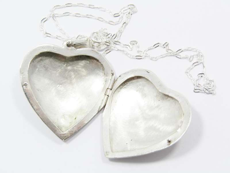 A Beautiful Vintage Design Engraved Heart Locket on Chain in Sterling Silver.
