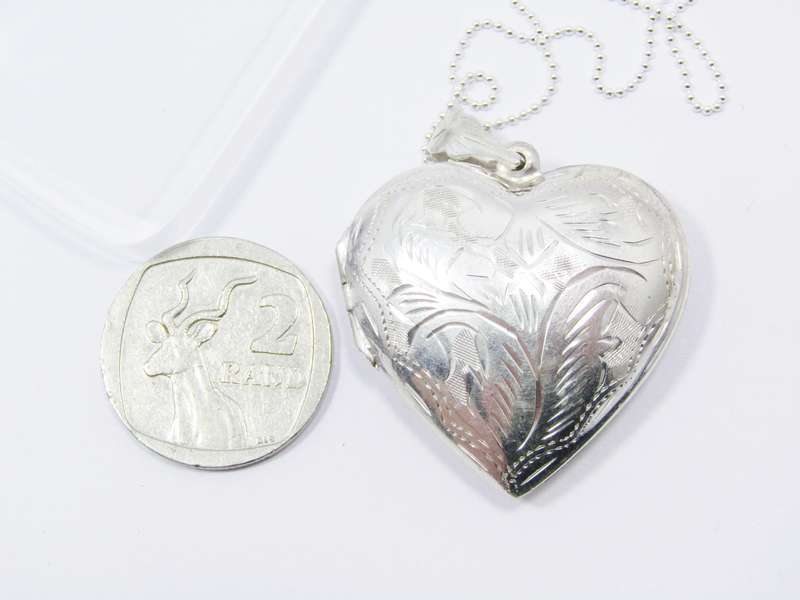 A Stunning Large Engraved Heart Locket On Chain in Sterling Silver.