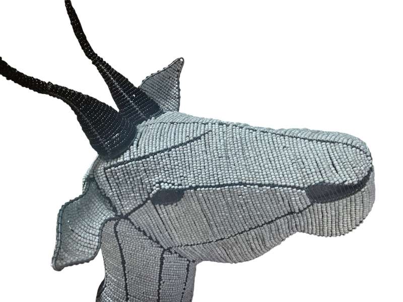 Head created from intricately threaded beads