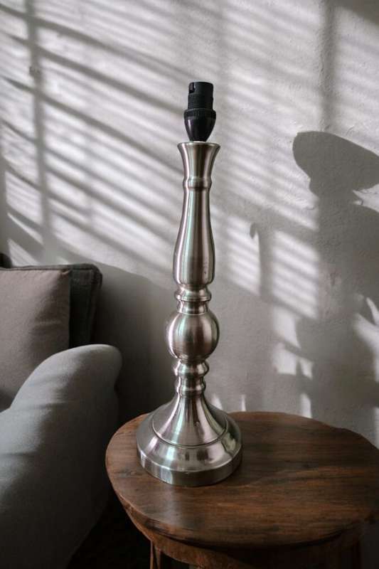 Add a touch of elegance to any space with this stunning Pillar Silver Metal Table Lamp.