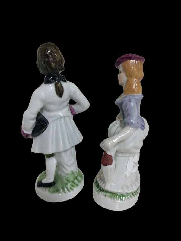 Exquisite Antique Victorian Couple Porcelain Figurines. Crafted with intricate details.
