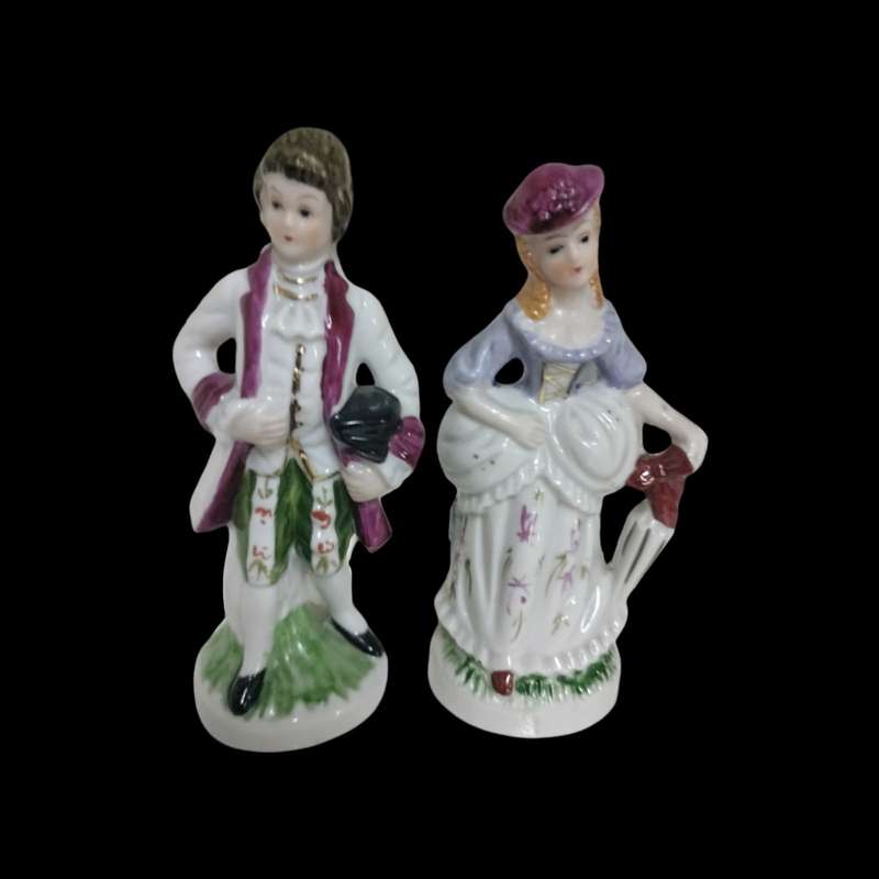 Exquisite Antique Victorian Couple Porcelain Figurines. Crafted with intricate details.
