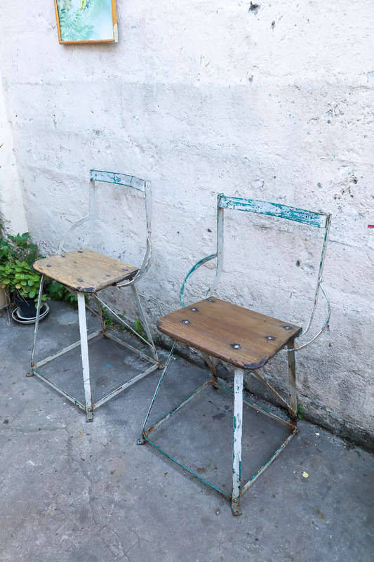 A pair of antique vintage Industrial worker chairs