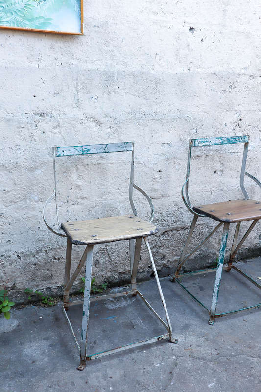 A pair of antique vintage Industrial worker chairs