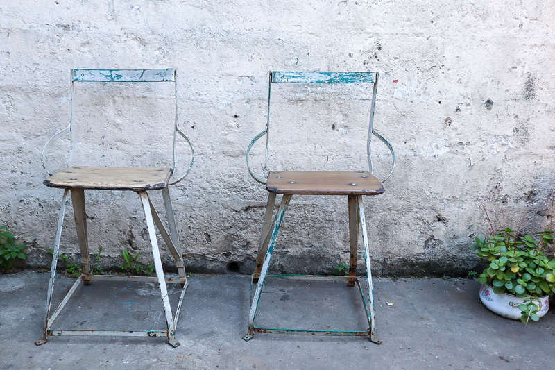 A pair of antique vintage Industrial worker chairs