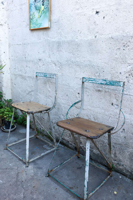 A pair of antique vintage Industrial worker chairs