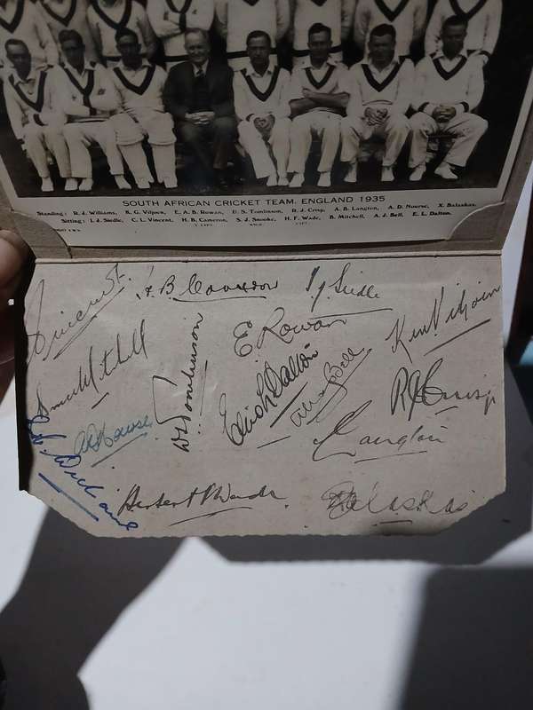 Real picture postcard of South African cricket team 1935 with full autograph sheet