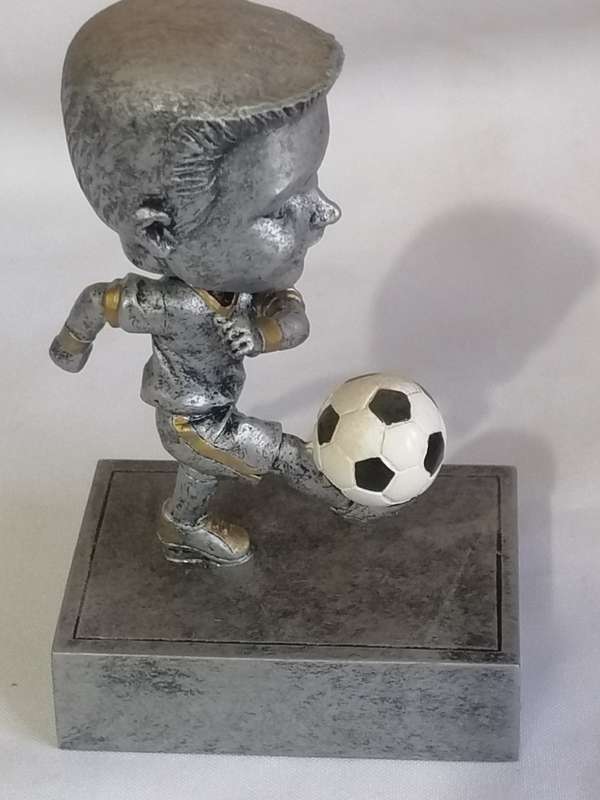 Resin kicking, Bubble head soccer trophy in unused condition.