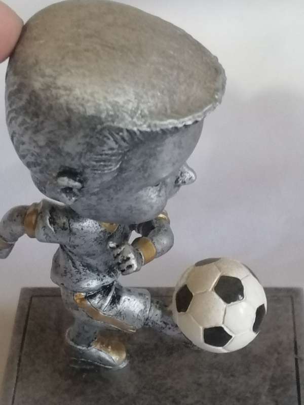 Resin kicking, Bubble head soccer trophy in unused condition.