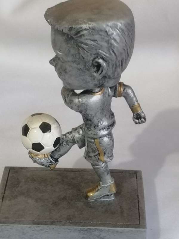 Resin kicking, Bubble head soccer trophy in unused condition.