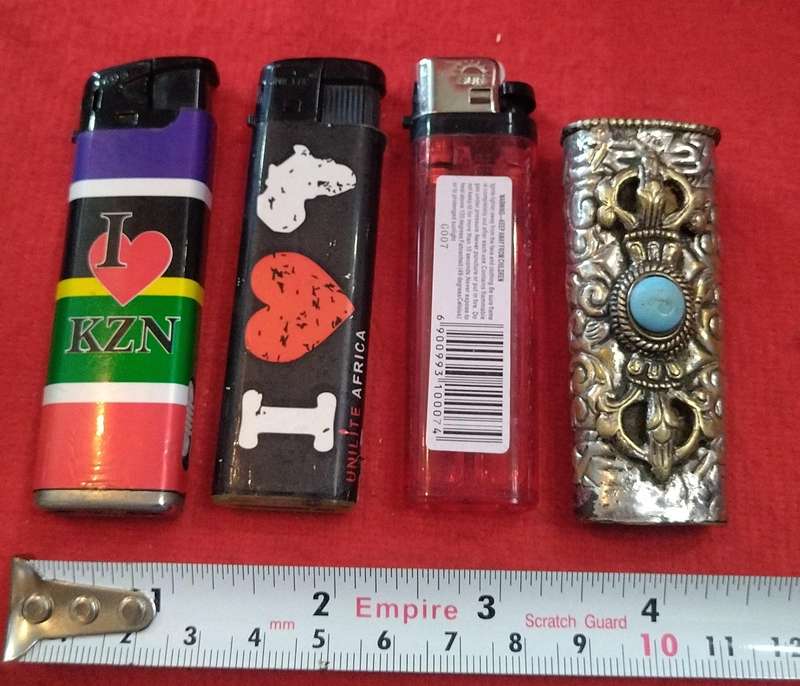 Assorted lighters (2 refillable) and a fancy metallic holder