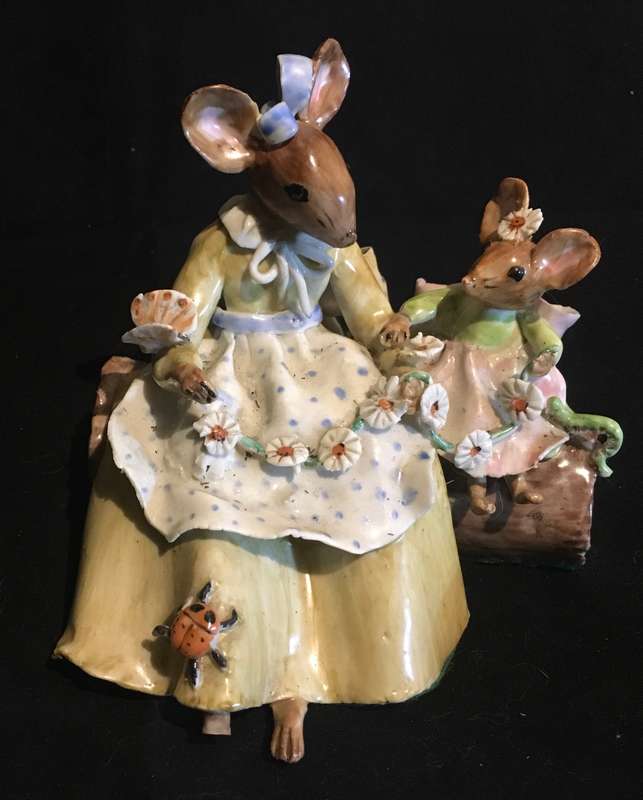 Porcelain mother and baby mouse on a log