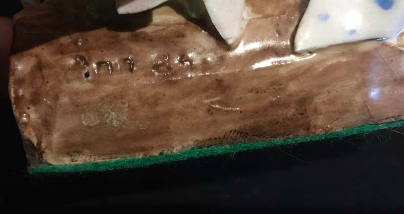 Porcelain mother and baby mouse on a log