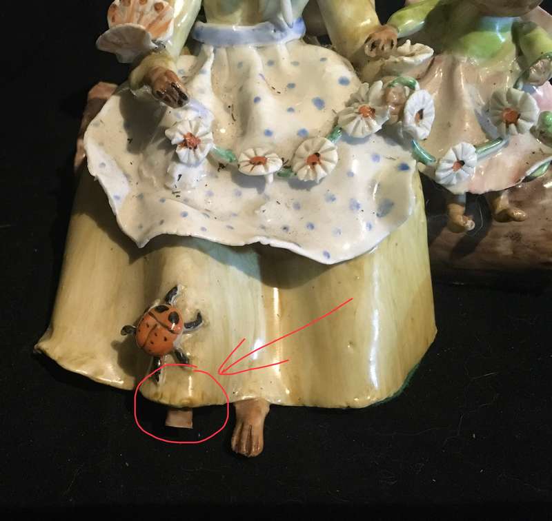 Porcelain mother and baby mouse on a log