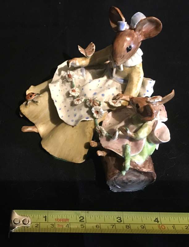 Porcelain mother and baby mouse on a log