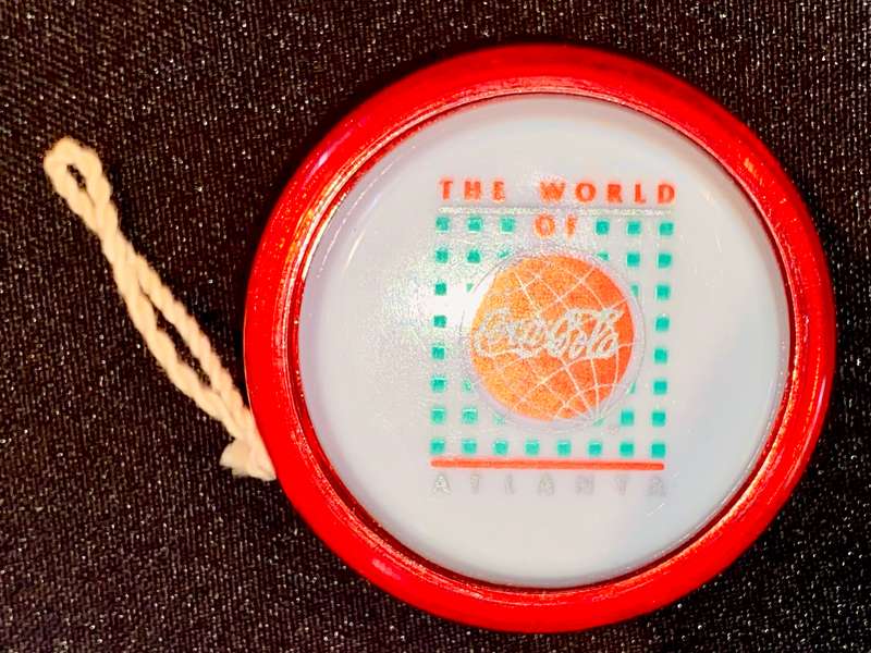 VINTAGE GENUINE COCA COLA RUSSELS SPINNER - THE WORLD OF ATLANTA - FIBERGLASS RIM GOOD CONDITION