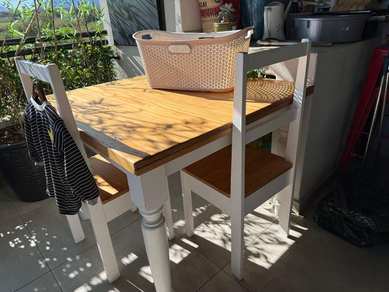 A set of wooden table and two chairs