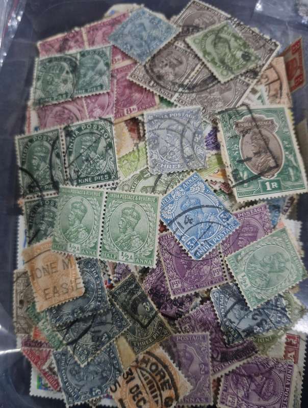 Packet of stamps from India including Queen Victoria, 3 British Kings, Service & official stamps etc