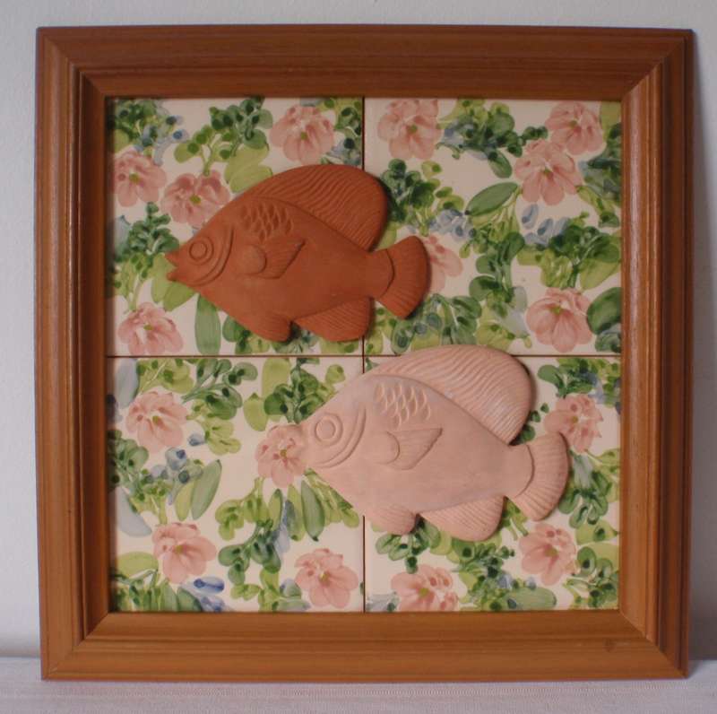 Hand crafted in Zimbabwe. Hand painted tiles with pottery fish attached. Arty wall hanging item