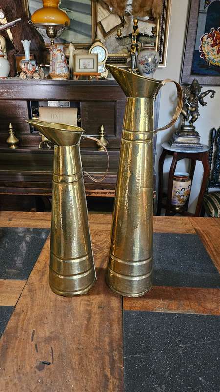 Two Tall Brass Pitchers