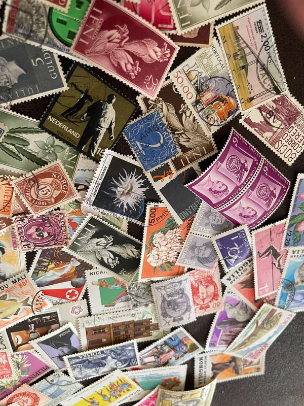 A COUPLE THOUSAND WORLD STAMPS OFF PAPER - 1