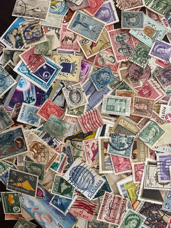 A COUPLE THOUSAND WORLD STAMPS OFF PAPER - 1