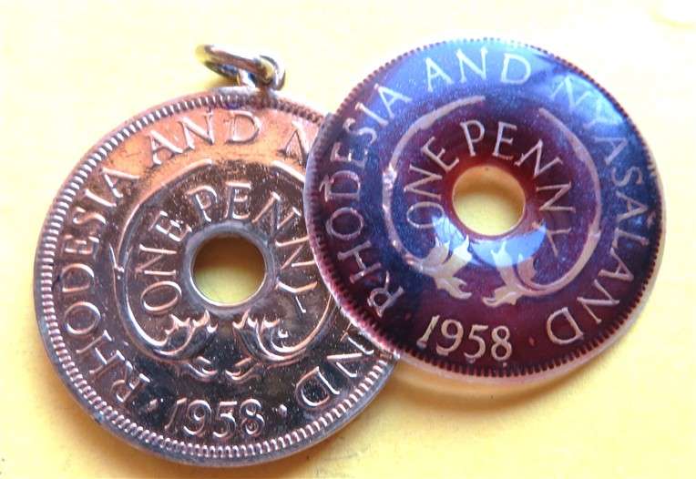 1958 Rhodesia & Nyasaland Gilt Penny with Enamelled Resin - 1 loose