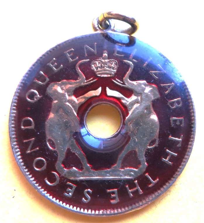 1958 Rhodesia & Nyasaland Gilt Penny with Enamelled Resin - 1 loose