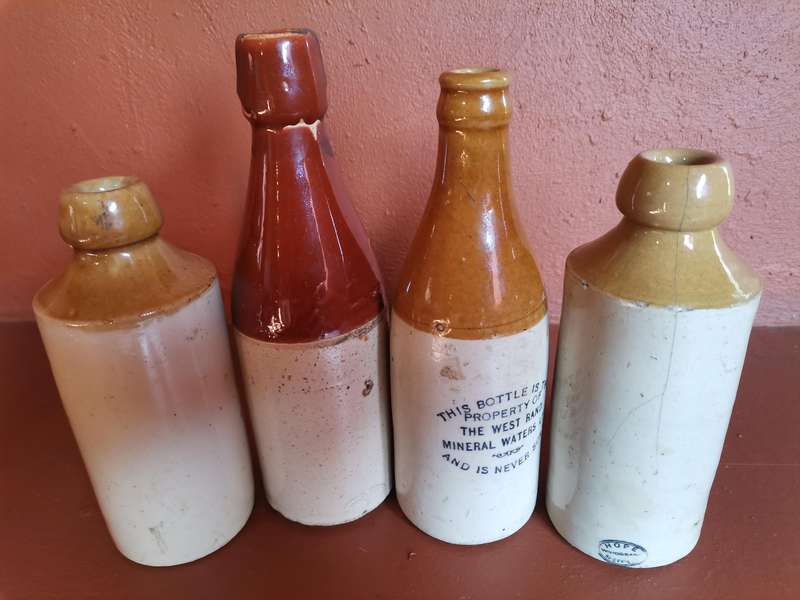 Four antique ginger beer bottles