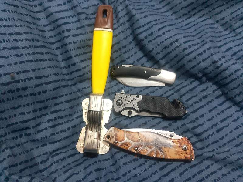 THREE FOLDING KNIVES AND ONE VINTAGE SHARPENER