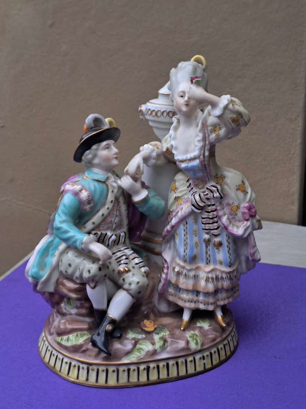 Porcelain stamped crown over M man courting lady