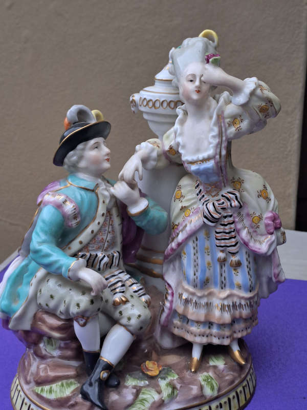Porcelain stamped crown over M man courting lady