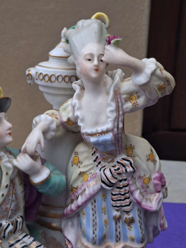 Porcelain stamped crown over M man courting lady