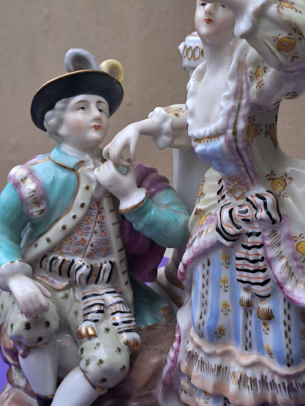 Porcelain stamped crown over M man courting lady