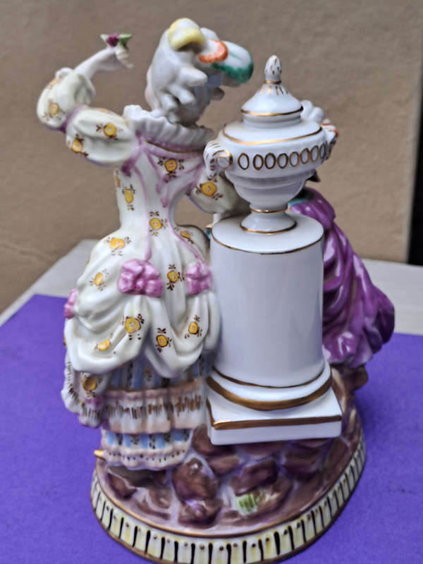 Porcelain stamped crown over M man courting lady