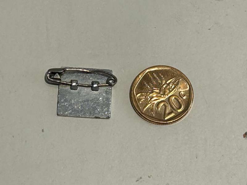 A metallic Coca Cola Coke Yo-Yo MASTER Badge