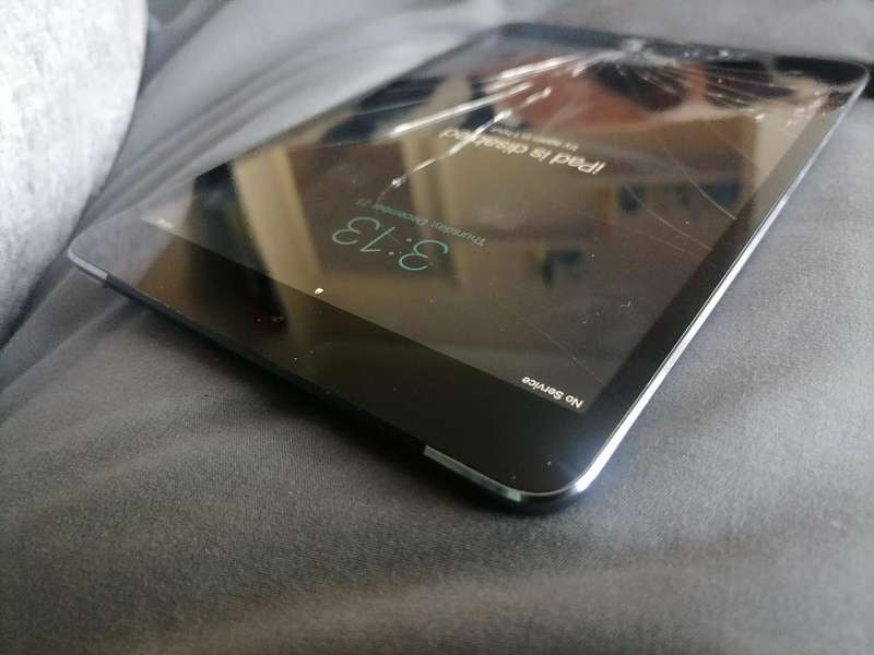 Apple iPad A1490 with pouch, front glass cracked. Sold as is.