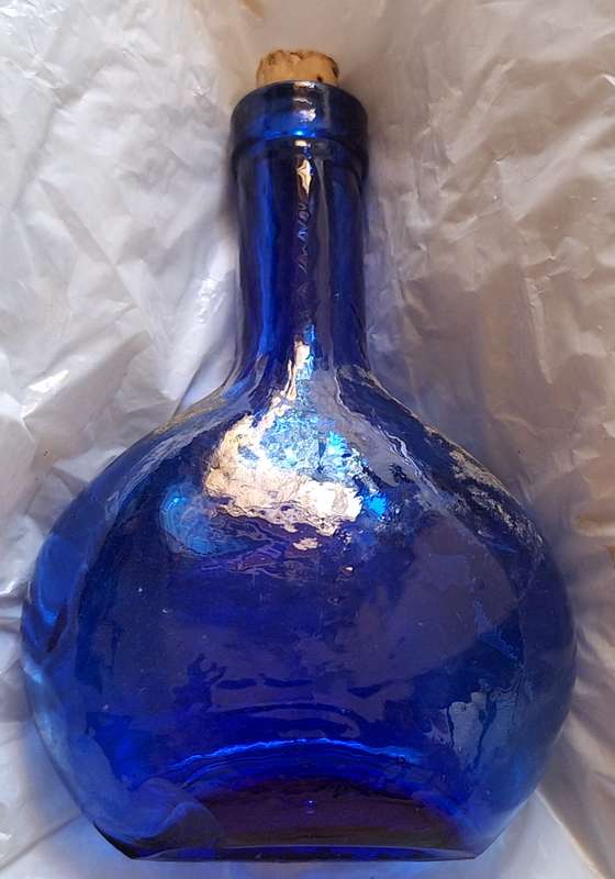 Small Blue Glass Bottle with Cork Stopper and Chip on Base