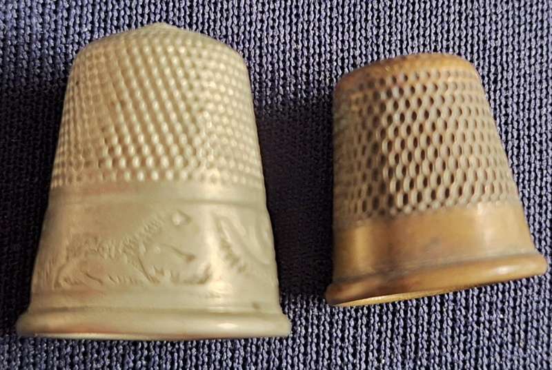 2 Metal Thimbles. Smaller has 4 on rim.  Larger Scroll design on rim.