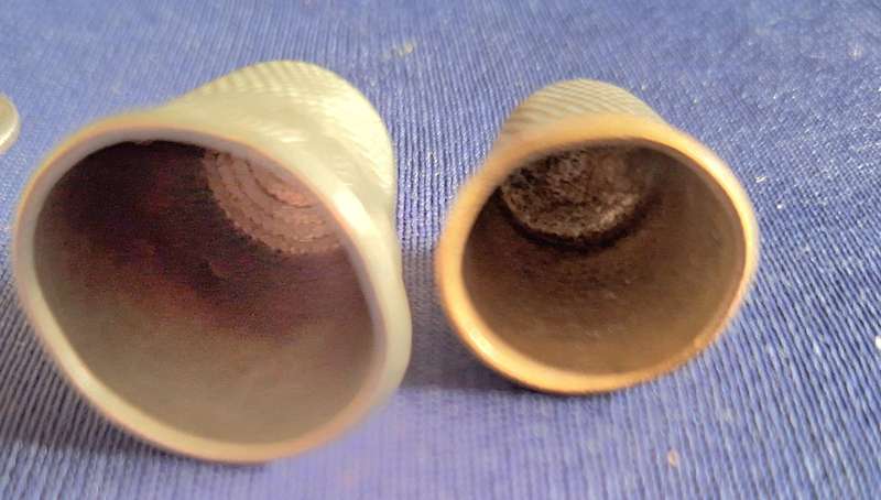 2 Metal Thimbles. Smaller has 4 on rim.  Larger Scroll design on rim.