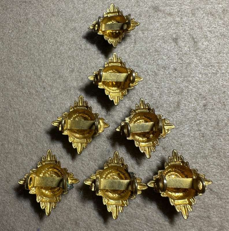 RHODESIA CROWNS AND PIPS - 7 BRASS PIPS WITH RED ENAMEL