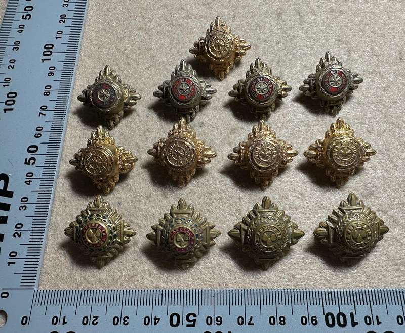 RHODESIA CROWNS AND PIPS - 13 BRASS PIPS WITH RED ENAMEL - VARIED